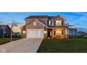 Charming two-story home featuring a basketball hoop, brick accents, and a well-maintained front yard at 6476 W Mulberry Way, Greenfield, IN 46140