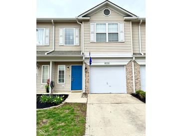 Charming townhome with a blue front door, a one car garage, and manicured landscaping at 8030 Windham Lake Way, Indianapolis, IN 46214