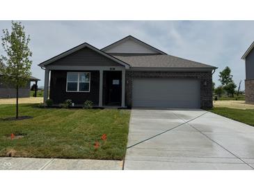 Charming single-Gathering home featuring a brick facade, attached garage, and freshly laid lawn at 915 Saddlebrook Farms Blvd, Whiteland, IN 46184