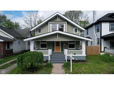 Charming two-story home features a well-maintained lawn and a welcoming front porch at 926 N Dearborn St, Indianapolis, IN 46201