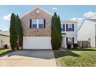Charming two-story home featuring a brick facade, two-car garage, and well-manicured lawn at 951 Brookstone Dr, Franklin, IN 46131