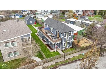 Detailed aerial view of two-story home featuring lush landscaping and backyard patio at 953 Harrison St, Indianapolis, IN 46202