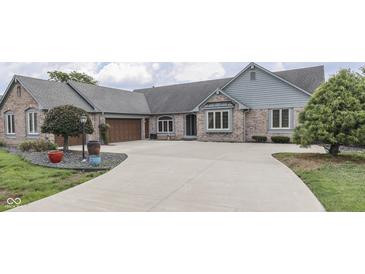 Charming brick home with a spacious driveway and a well-manicured front yard at 1021 Hudson Bay Dr, Greenwood, IN 46142