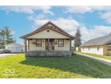 Charming bungalow featuring a covered front porch and well-maintained lawn at 12125 Broadway St, Indianapolis, IN 46236