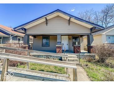 Charming single-story home with a covered front porch, ramp, and updated siding at 1351 S Belmont Ave, Indianapolis, IN 46221