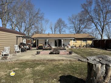 Spacious backyard featuring a patio, fire pit, and well-maintained lawn, perfect for outdoor gatherings at 445 E 1000 N, Alexandria, IN 46001
