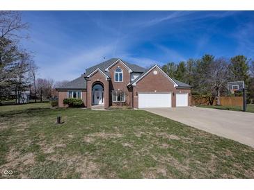 Beautiful two story brick home with a three car garage and well maintained lawn at 4644 S Grassy Ct, New Palestine, IN 46163