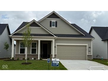 Charming single-story home with neutral siding, a two-car garage, and manicured front lawn and classic architectural details at 5653 Stetson Dr, Whitestown, IN 46052