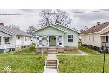 Charming home featuring a well-maintained lawn and a delightful lattice-covered front porch at 831 Wallace Ave, Indianapolis, IN 46201