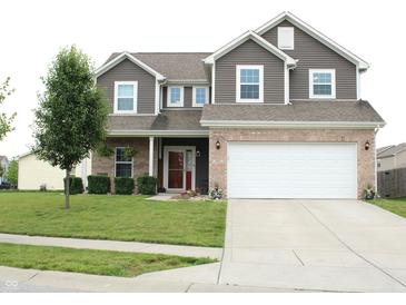 Inviting two-story home with a manicured lawn and a two-car garage at 981 Redwood Dr, Franklin, IN 46131