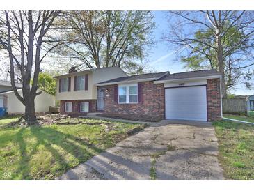 Charming front exterior of a split level home featuring a brick facade and attached garage at 10321 Starview Dr, Indianapolis, IN 46229