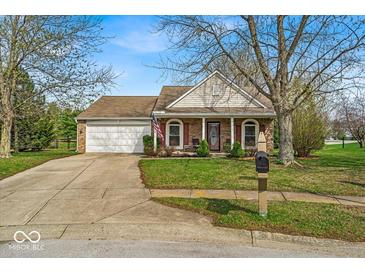 Charming one-story home with a two-car garage and well-maintained lawn at 10407 Stillwell Ct, Avon, IN 46123