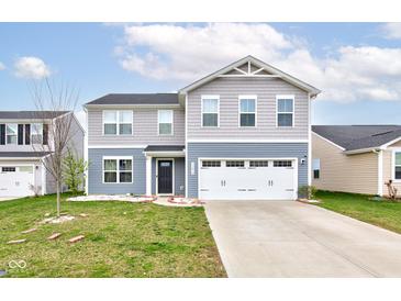 Charming two-story home with a two-car garage, manicured lawn and inviting curb appeal at 13872 N Mardenis W Dr, Camby, IN 46113
