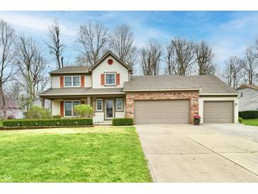 Charming two-story home with a three car garage and a well-maintained lawn and landscaping at 381 Stoneybrook Grove Dr, Greenwood, IN 46142