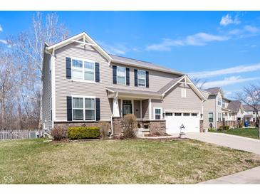Charming two-story home featuring vinyl siding, black shutters, and an attached two-car garage at 4846 Shakamak Ct, Indianapolis, IN 46239