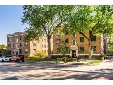 Charming brick apartment building featuring mature trees and manicured landscaping at 5347 N College Ave # Apt 109, Indianapolis, IN 46220