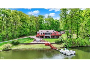 A charming waterfront home with a private dock and lush green landscaping at 5571 Poff Rd, Martinsville, IN 46151
