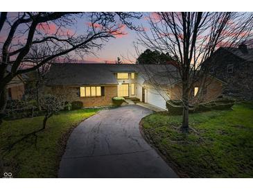 Charming single-Gathering home boasts a brick facade, attached garage, and a curved driveway at 6140 Buttonwood Dr, Noblesville, IN 46062