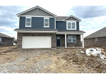 Two-story home with blue siding, brick facade, white trim, and an attached two-car garage. Ready to be lived in at 905 Saddlebrook Farms Blvd, Whiteland, IN 46184