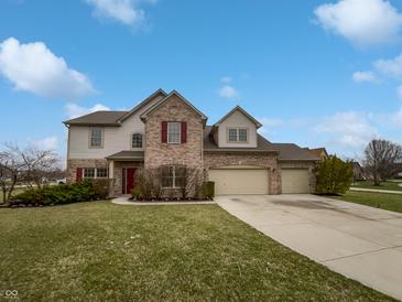 Charming two-story home with a three-car garage, brick accents, and a well-manicured lawn at 9237 Stones Ferry Pl, Indianapolis, IN 46278