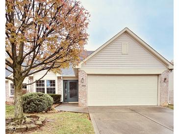Charming single-Gathering home featuring a two-car garage, brick accents, and mature landscaping at 10949 Harness Way, Indianapolis, IN 46239