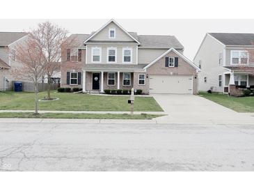 Charming two-story home with a combination of siding and brick, complemented by a well-manicured lawn at 11149 Titania Ct, Noblesville, IN 46060