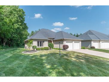 Charming brick home featuring a two-car garage, lush lawn, and beautifully landscaped front yard at 1238 Passage Way, Plainfield, IN 46168