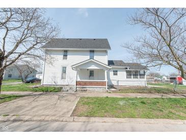 Charming two-story home with white siding and a well-maintained front yard on a clear day at 1403 Lafayette Ave, Columbus, IN 47201