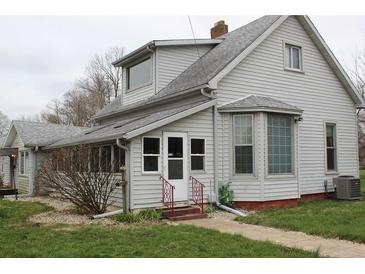 Charming home with a gable roof, gray siding, and well-maintained landscaping, offering classic appeal at 1700 S Perdieu Rd, Muncie, IN 47302