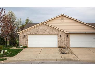 Two-car attached garage with brick facade and white doors offers ample parking and curb appeal at 172 Arabian Ct, Whiteland, IN 46184