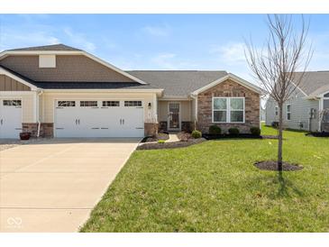Charming single-story home with a well-manicured lawn and attached two-car garage at 181 Kiawah Dr, Whiteland, IN 46184
