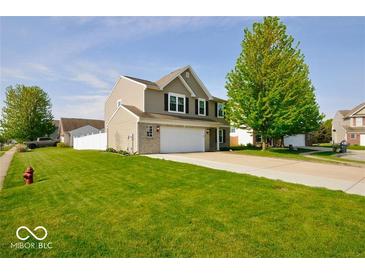 Charming two-story home with a well-manicured lawn, an attached garage, and appealing curb appeal at 2009 Quarter Path Rd, Cicero, IN 46034