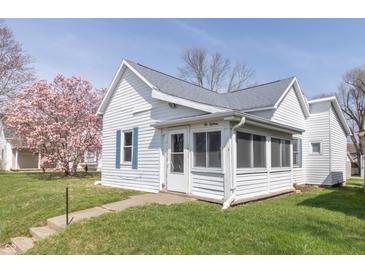 Charming single Gathering home with white siding, gray roof, and colorful landscaping at 218 Illinois St, Shirley, IN 47384