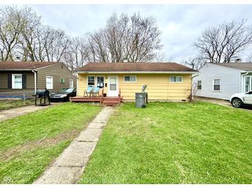 Charming one story home with yellow painted siding, and walkway leading to the front door at 3536 N Hawthorne Ln, Indianapolis, IN 46218