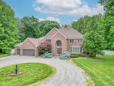 Traditional brick home featuring an oversized front lawn, circular driveway, and mature trees at 4743 Little Hurricane Rd, Martinsville, IN 46151