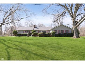 Charming ranch-style home with a well-manicured lawn and mature trees at 5913 W Maple Dr, Frankton, IN 46044