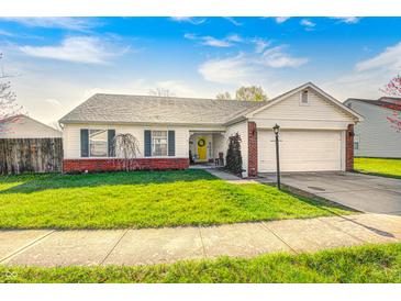Charming single-story home with a well-manicured lawn, attached garage, and inviting curb appeal at 6431 Meadowpond Way, Indianapolis, IN 46235