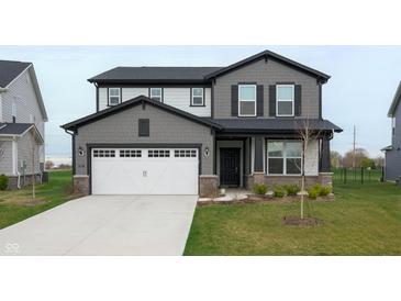 Two-story home featuring a two-car garage, dark grey exterior trim and a well manicured lawn at 6925 Sable Point Dr, Brownsburg, IN 46112