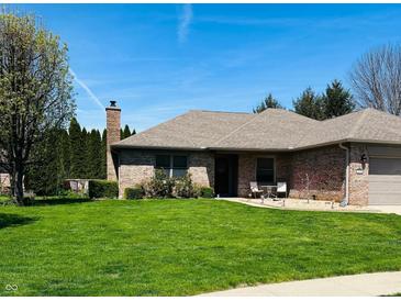 Well-maintained brick home with a lush green lawn and manicured landscaping at 1030 Pamela Dr, Plainfield, IN 46168