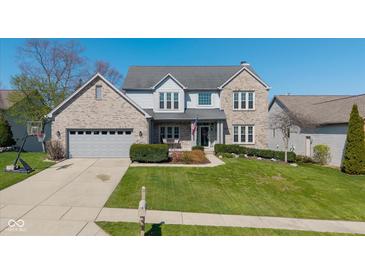 Charming two-story home with a brick facade, well-manicured lawn, and an attached two-car garage at 11050 Midnight Pass, Fishers, IN 46037