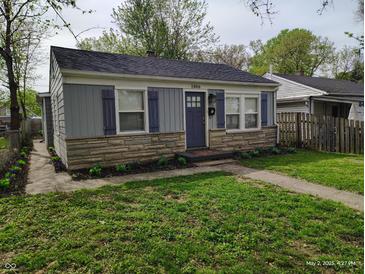 Charming one-story home with stone accents, blue shutters, and a well-maintained lawn at 1806 Asbury St, Indianapolis, IN 46203