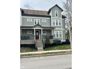 Charming exterior view with a welcoming front porch and beautiful landscaping at 2250 N Pennsylvania St # 8, Indianapolis, IN 46205