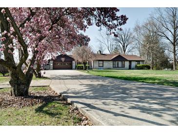 Charming ranch home with long driveway, basketball hoop, mature trees and beautiful magnolia tree at 6047 W 56Th St, Indianapolis, IN 46254