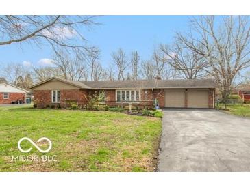 Charming brick home with a well-manicured front yard and long driveway at 7915 Allisonville Rd, Indianapolis, IN 46250