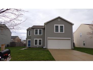 Charming two-story home with a two-car garage, green lawn, and light-gray siding at 796 Hickory Pine Dr, Whiteland, IN 46184