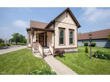 Charming exterior of a two-story home with a well-manicured lawn and inviting front porch at 804 N California St, Indianapolis, IN 46202