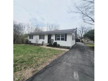 Charming single story home featuring a well-maintained lawn and a long driveway at 1024 Foltz St, Indianapolis, IN 46241