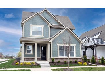 Charming two-story home with blue siding, brick accents, a covered front porch, and manicured landscaping at 15109 Larchwood Dr, Westfield, IN 46074