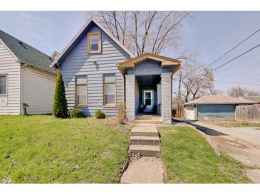 Charming bungalow-style home with blue siding, covered porch, and well-maintained lawn at 1614 S Talbott St, Indianapolis, IN 46225