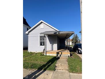 Charming single-story home with a covered porch and vinyl siding, located on a sunny lot at 2111 Central Ave, Anderson, IN 46016
